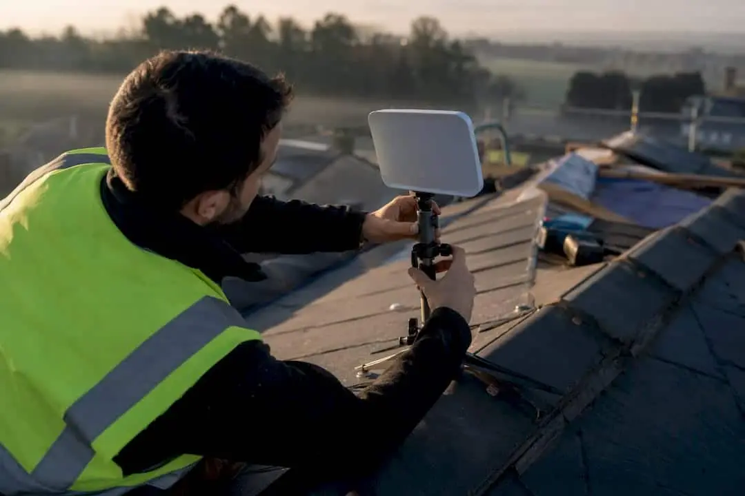 Contractor adjusting roofing antenna device