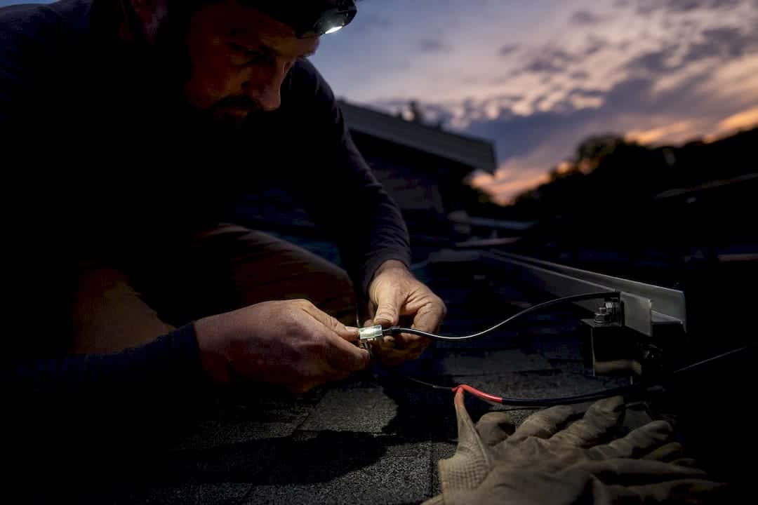Hands inspecting wiring connector for offline tracking issue